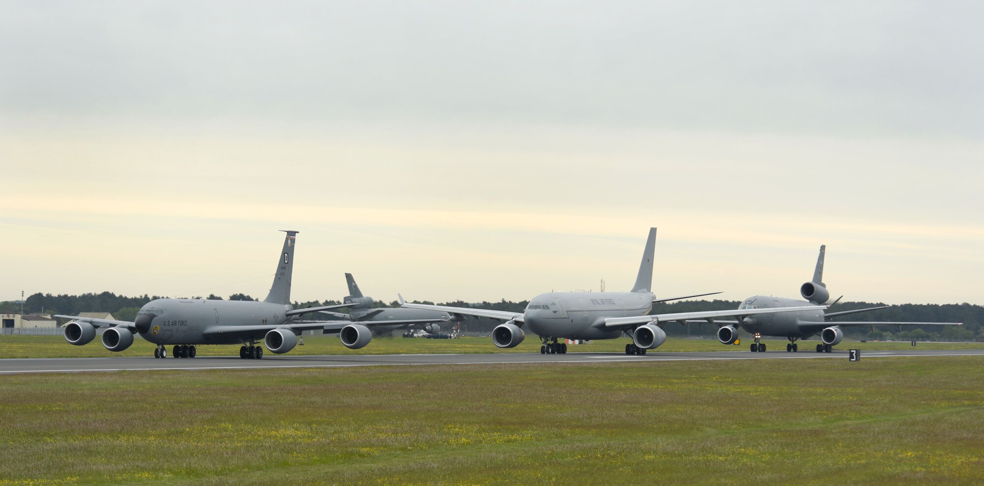 A U.S. Air Force KC-135 Stratotanker, Royal Air Force A330 Voyager and U.S. Air Force KC-10 Extender aircraft perform an “elephant walk” down the runway May 20, 2021, at RAF Mildenhall, England. The elephant walk, followed by a formation flight, was part of the European tanker Symposium which brings tanker crew from NATO countries, along with other U.S. and Canadian forces together to share experiences and knowledge. (U.S. Air Force photo by Karen Abeyasekere)