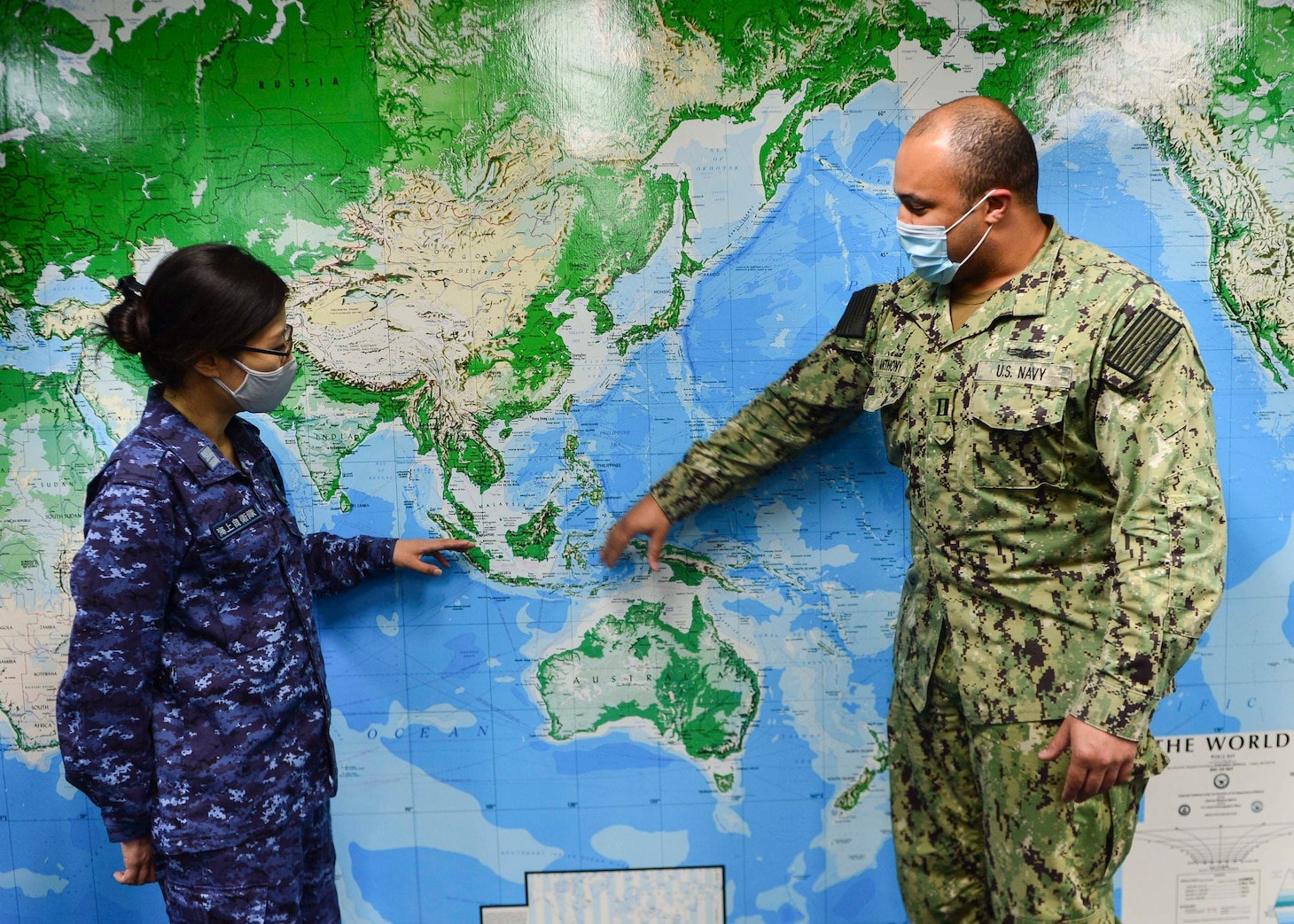 SINGAPORE (May 5, 2021) – Japan Maritime Self-Defense Force (JMSDF) Lt. Cmdr. Yoko Ukegawa, JMSDF liaison officer at Commander, Logistics Group Western Pacific (COMLOG WESTPAC), and U.S. Navy Lt. William Anthony, assistant replenishment officer with COMLOG WESTPAC, discuss potential replenishment-at-sea locations in the COMLOG WESTPAC conference room. (U.S. Navy photo by Mass Communication Specialist 1st Class Greg Johnson)