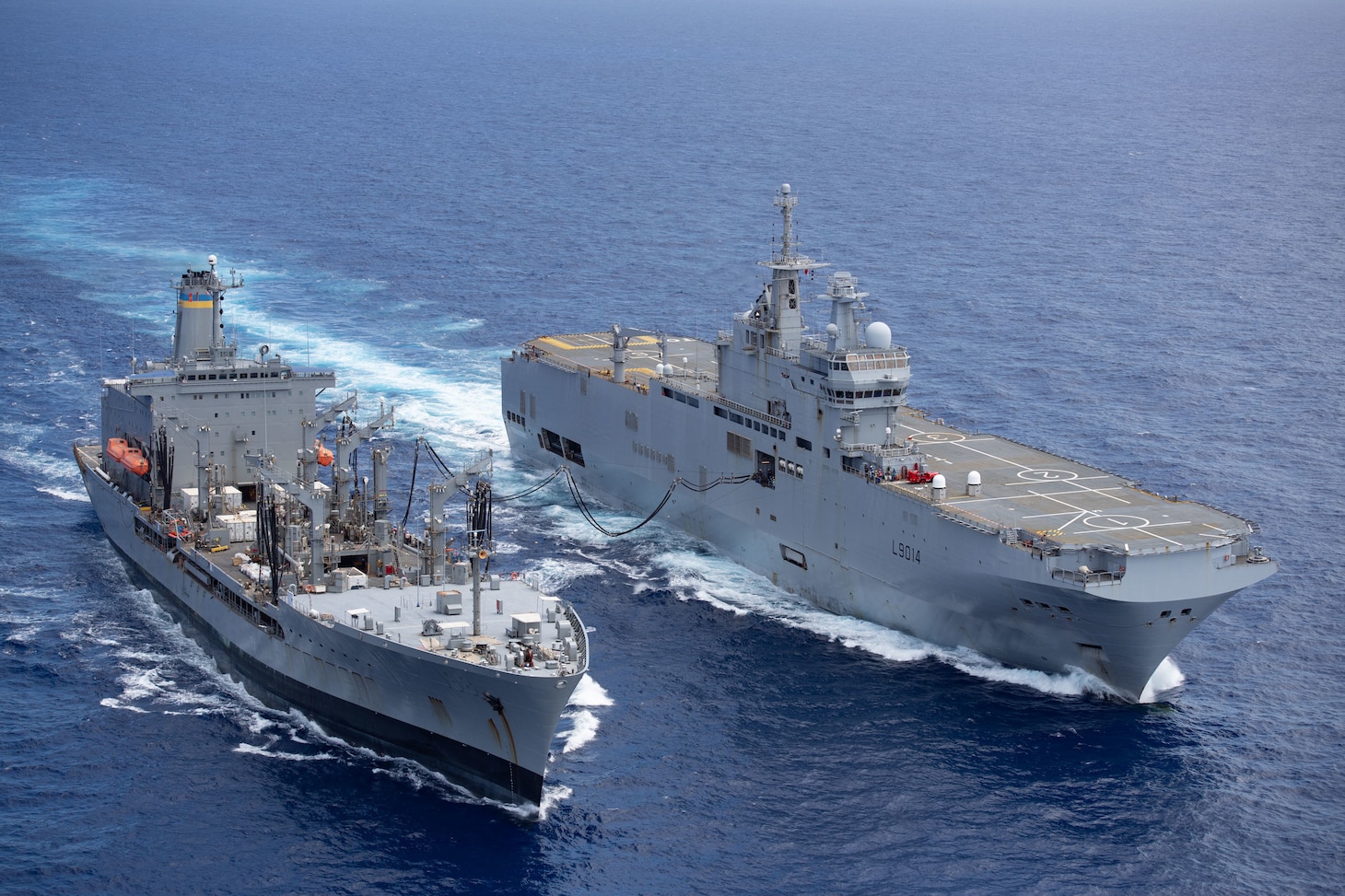 PHILIPPINE SEA (May 19, 2021) - The U.S. Navy's fleet replenishment oiler USNS Big Horn (T-AOE 6), left, conducts an underway replenishment with the French Navy's amphibious assault ship FS Tonnerre (L 9014). (Photo courtesy of the French Navy)