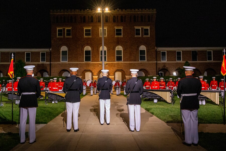 Marines with the parade staff stand at “ceremonial-at-ease” during the Friday Evening Parade at Marine Barracks Washington, May 21, 2021. The guest of honor for the evening was Her Excellency Karen E. Pierce, DCMG British Ambassador to the United States, and the hosting official for the evening was Lt. Gen. Lewis A. Craparotta, commanding general, Training and Education Command. (U.S. Marine Corps photo by Lance Cpl. Allen Sanders)