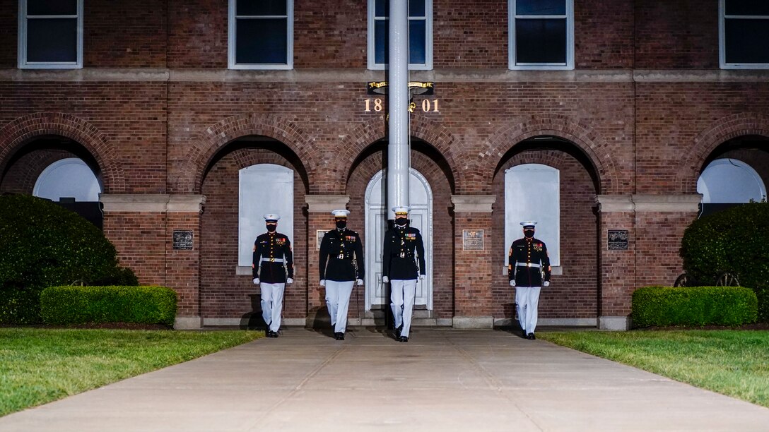 Marines with the parade staff march down Center Walk during the Friday Evening Parade at Marine Barracks Washington, May 21, 2021. The guest of honor for the evening was Her Excellency Karen E. Pierce, DCMG British Ambassador to the United States, and the hosting official for the evening was Lt. Gen. Lewis A. Craparotta, commanding general, Training and Education Command. (U.S. Marine Corps photo by Sgt. Jason Kolela)