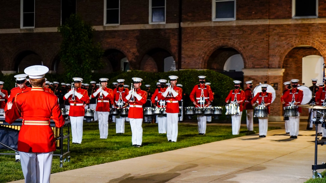 Chief Warrant Officer 2 Courtney Lawrence, assistant director, “The Commandant’s Own,” U.S. Marine Drum and Bugle Corps, conducts the Drum and Bugle Corps’ performance during the Friday Evening Parade at Marine Barracks Washington, May 21, 2021. The guest of honor for the evening was Her Excellency Karen E. Pierce, DCMG British Ambassador to the United States, and the hosting official for the evening was Lt. Gen. Lewis A. Craparotta, commanding general, Training and Education Command. (U.S. Marine Corps photo by Sgt. Jason Kolela)