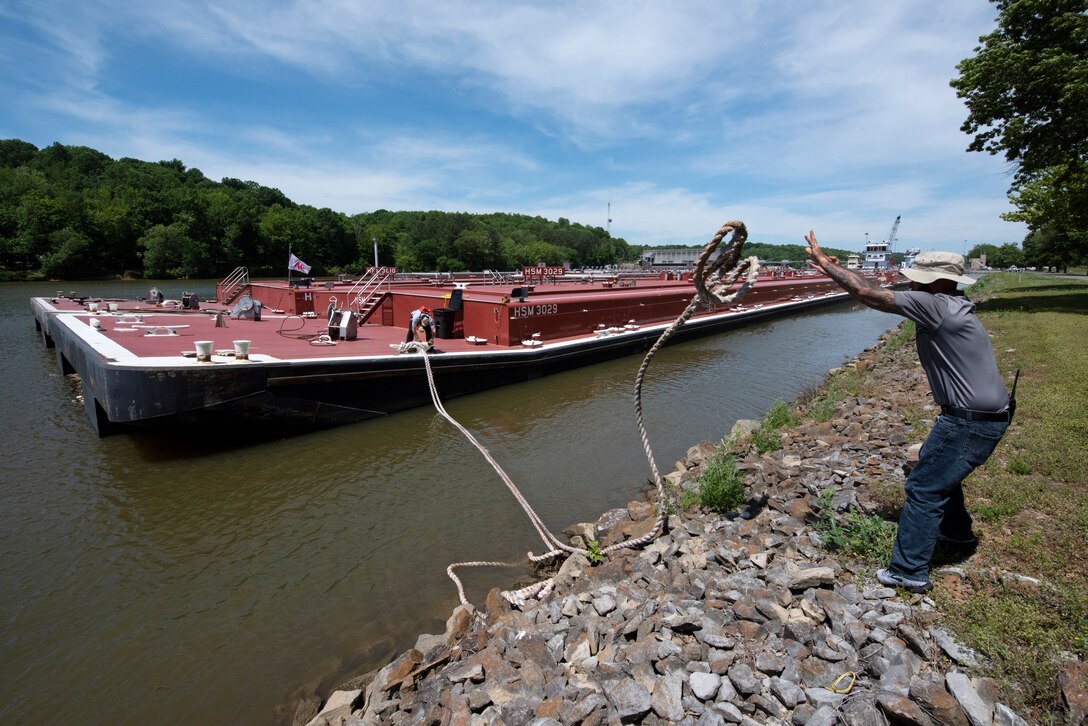 The crew of the Motor Vessel Tampa out of Ashland, Kentucky, prepares to depart Cheatham Lock May 21, 2021 with Marathon Petroleum Company fuel barges headed to terminals in Nashville. The U.S. Army Corps of Engineers Nashville District worked with the fuel industry and Regional Rivers Repair Fleet, which is performing maintenance at the lock, to schedule openings to accommodate deliveries of fuel to Middle Tennessee. Each barge carries around 28,000 barrels of fuel. (USACE Photo by Lee Roberts)