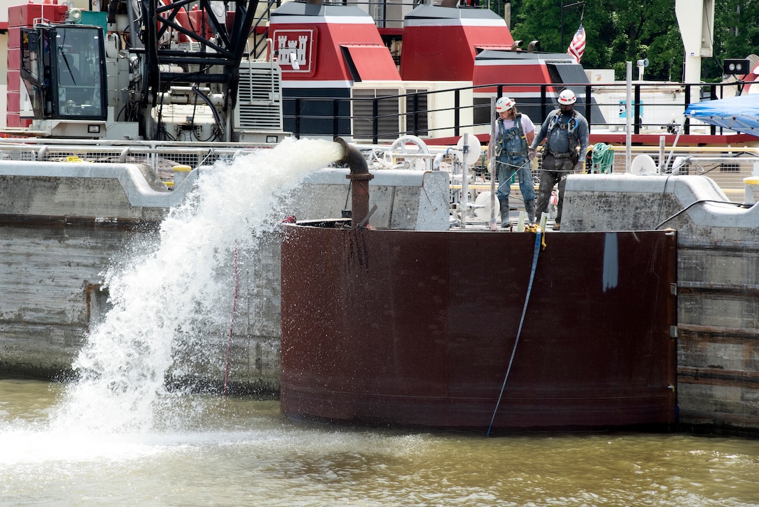 Maintenance members with the Regional Rivers Repair Fleet out of the U.S. Army Corps of Engineers Huntington District wait for a pump to remove water from a dewatering box May 21, 2021 that is anchored to the lock wall at Cheatham Lock in Ashland City, Tennessee. It made it possible for the maintenance crew to work in dry conditions. They were working in between lockages of Marathon Petroleum Company fuel barges. The U.S. Army Corps of Engineers Nashville District worked with the fuel industry and Regional Rivers Repair Fleet, which is performing maintenance at the lock, to schedule openings to accommodate barges moving up and down the Cumberland River fueling Middle Tennessee in the wake of a recent gas shortage. (USACE Photo by Lee Roberts)