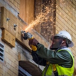 Man working on exterior of building