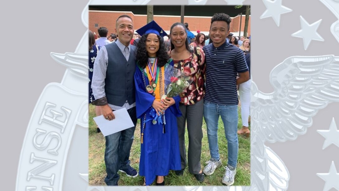 Patricia Wilkins stands with her husband and two children during her daughter’s graduation