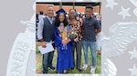 Patricia Wilkins stands with her husband and two children during her daughter’s graduation