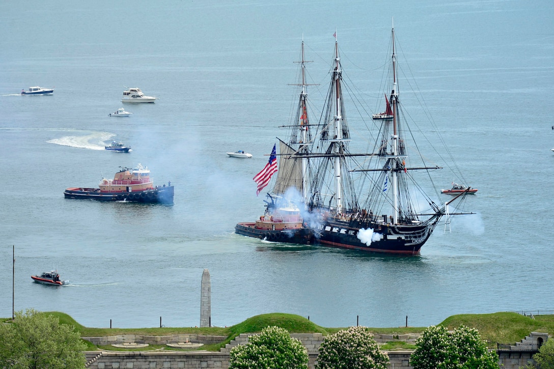 An old three-masted ship is pulled through the water.