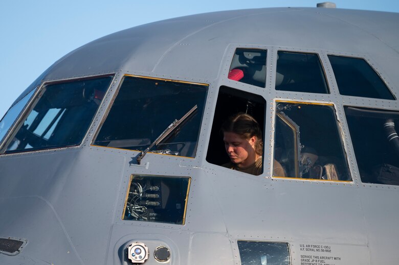 An Airman preforms pre-flight checks of a C-130J