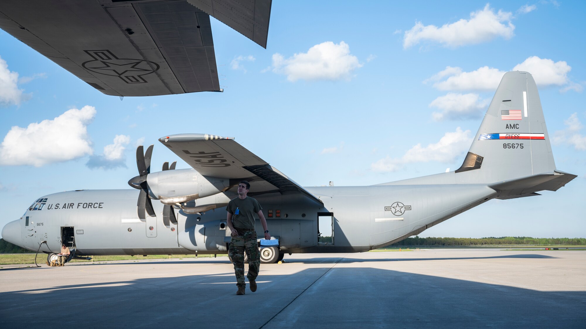 An Airman preforms pre-flight checks of a C-130J
