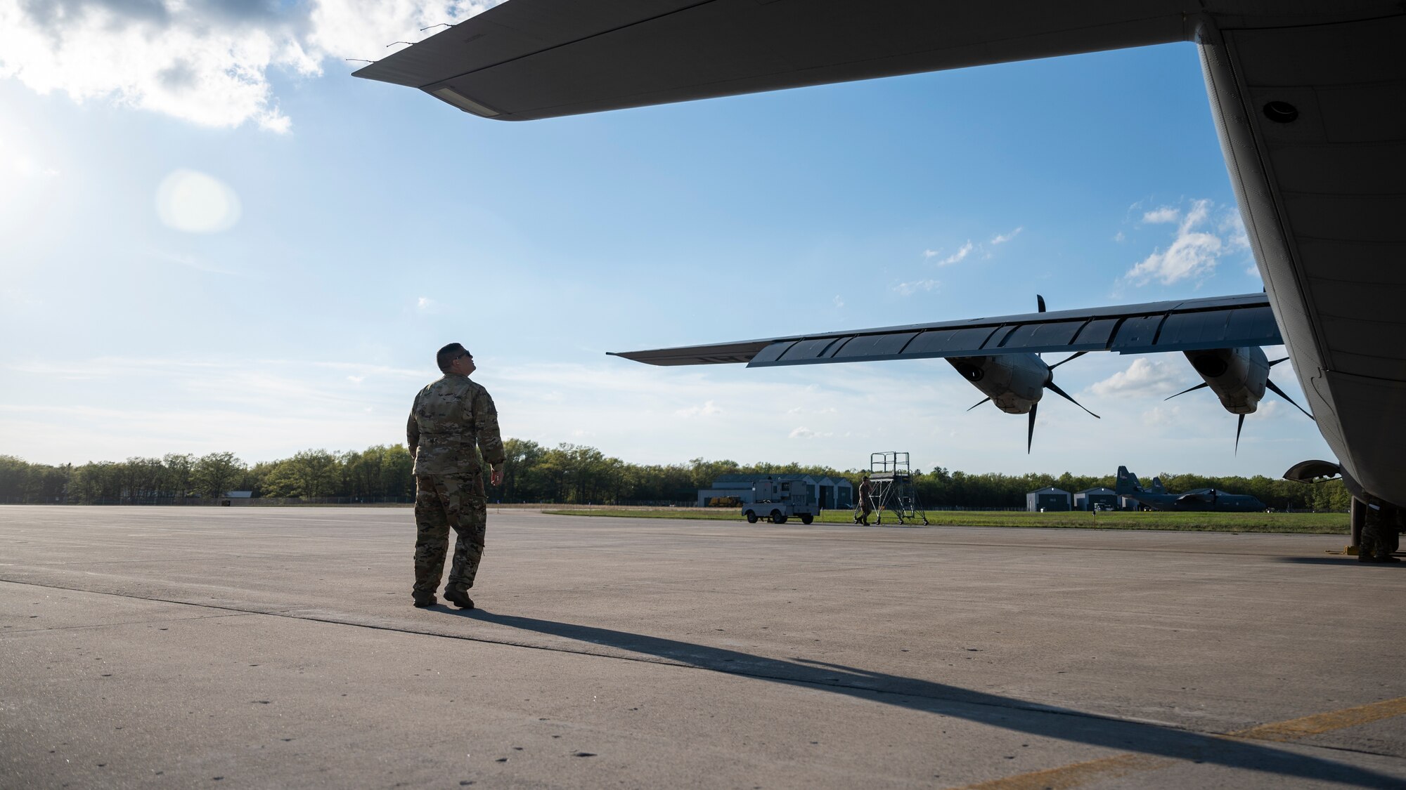 An Airman preforms pre-flight checks of a C-130J