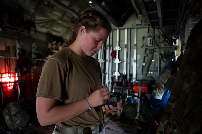 An Airman prepares pre-flight checks of a C-130J