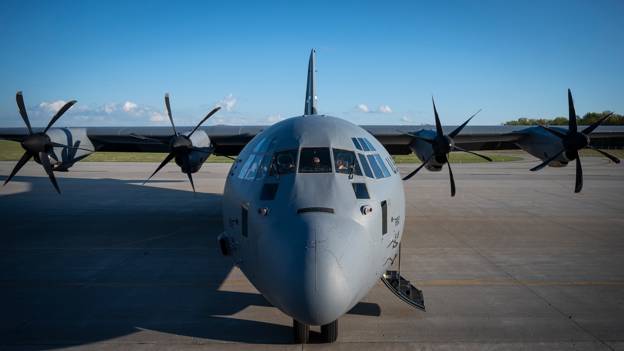 Airmen prepare pre-flight checks on a C-130J
