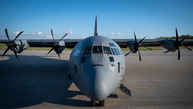 Airmen prepare pre-flight checks on a C-130J