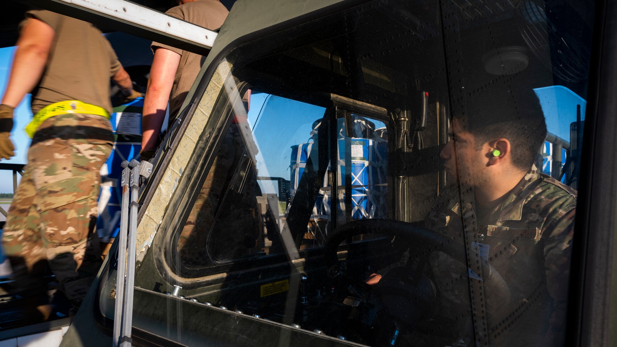 An air transportation specialist watches other Airmen