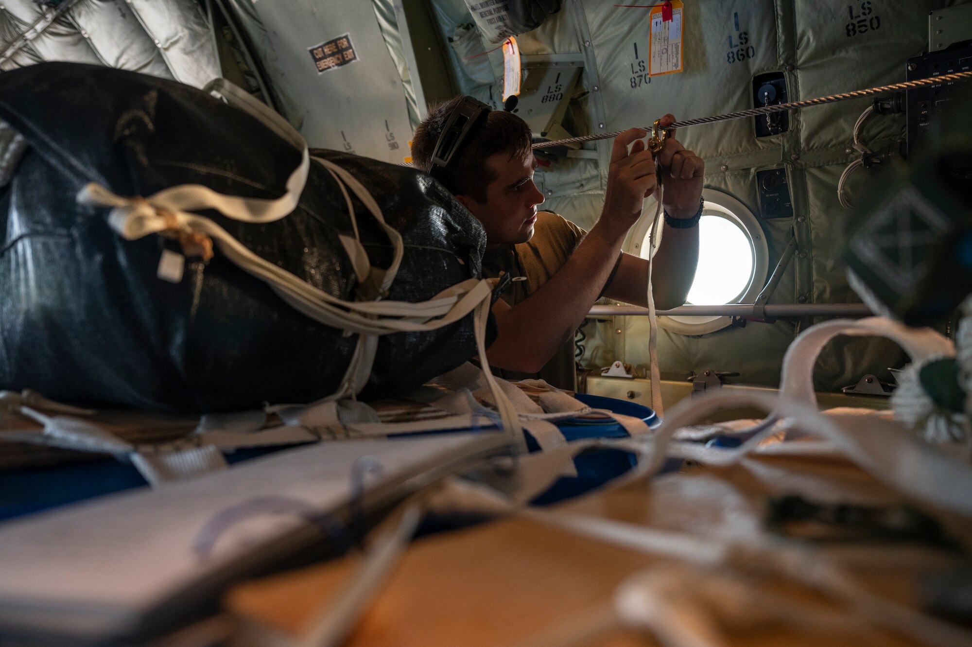 A loadmaster rigs a container delivery system