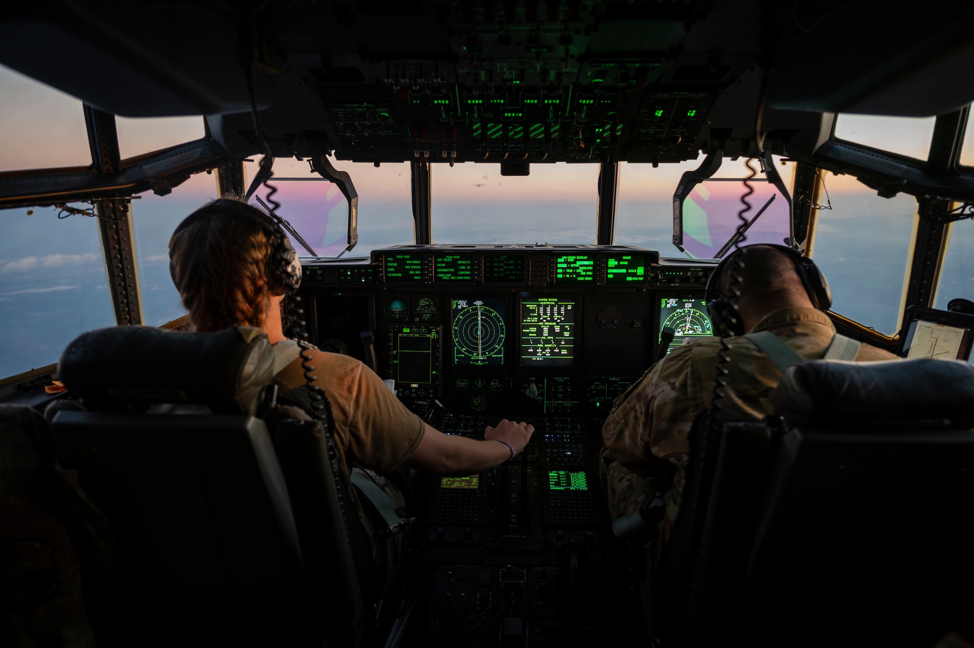 Pilots fly a C-130J