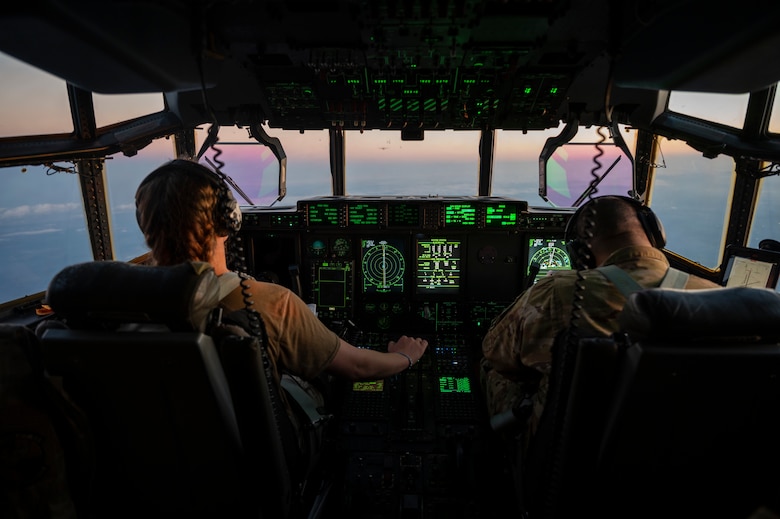 Pilots fly a C-130J