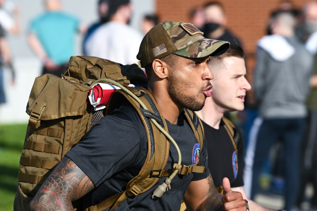 Airmen from the 316th Security Forces Group participate in a ruck march during National Police Week, May 11, 2021, at Joint Base Andrews, Md. During the Wingman/Shipmate Day 5K event, the 316th SFG participated in their own run, carrying heavy rucksacks and gear throughout their journey. (U.S. Air Force photo by Airman 1st Class Bridgitte Taylor)