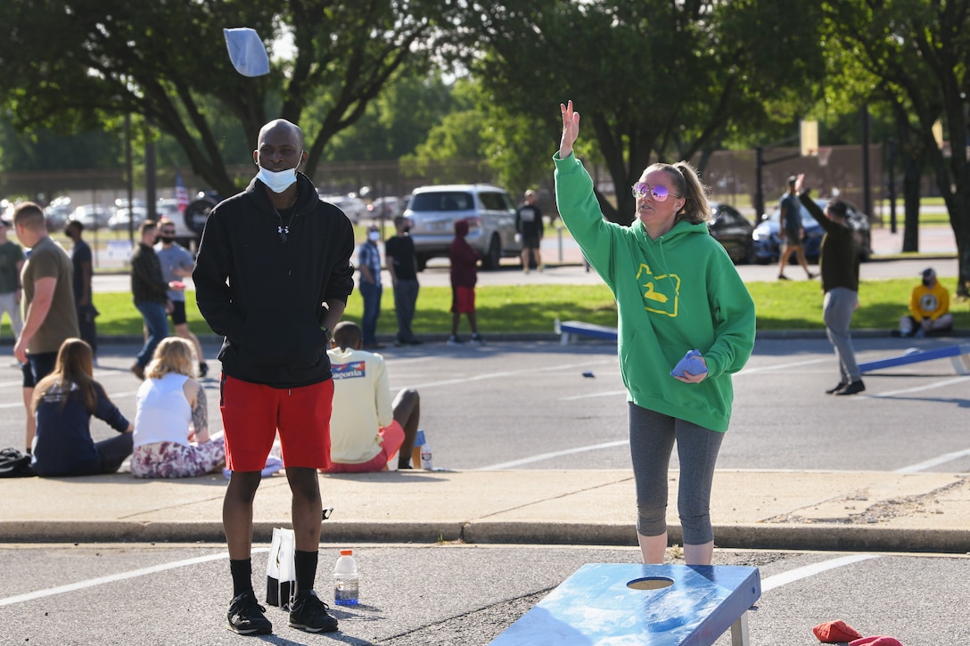 Joint Base Andrews Airmen participate in a cornhole tournament during Wingman/Shipmate Day, meant for service members to compete and strengthen the bonds between squadrons, at JBA, Md., May 11, 2021. Different activities were held around base to give those participating a wide variety of events from which to choose. (U.S. Air Force photo by Airman 1st Class Bridgitte Taylor)