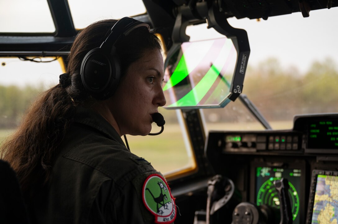 Airmen preform a pre-flight check of a C-130J