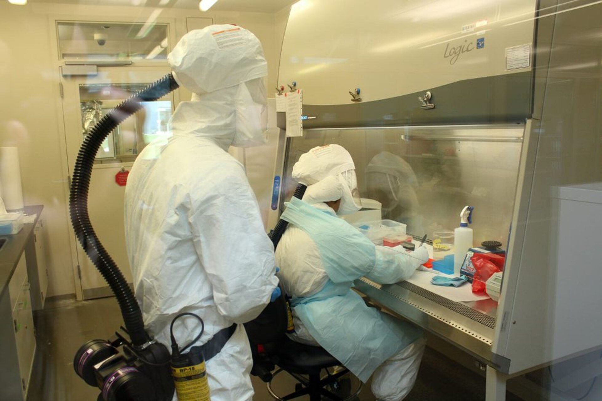 Lugar Center scientists working in laboratory hood to identify and overcome infectious disease threats in Georgia