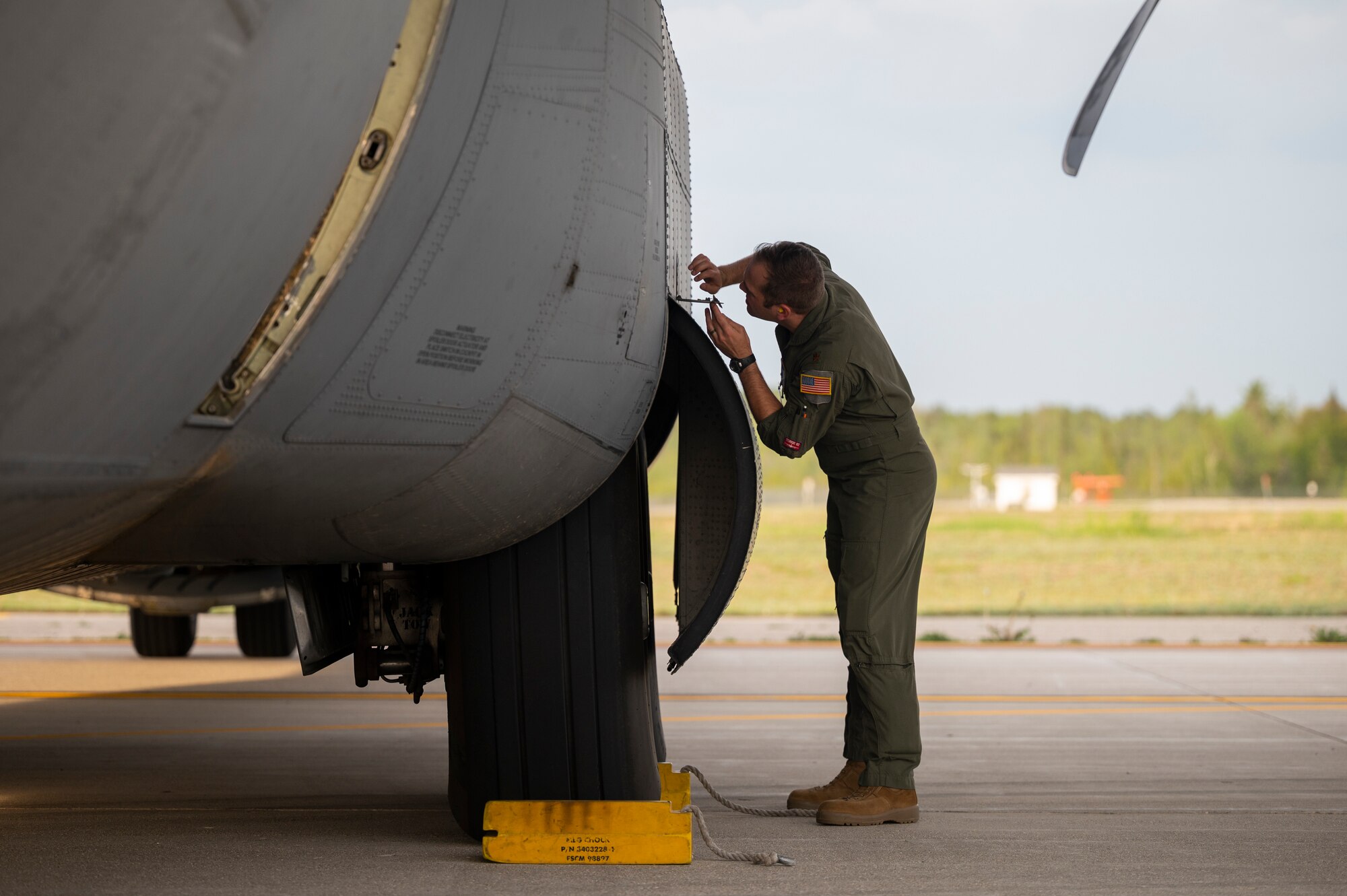 An Airman preforms a pre-flight inspection of a C-130J