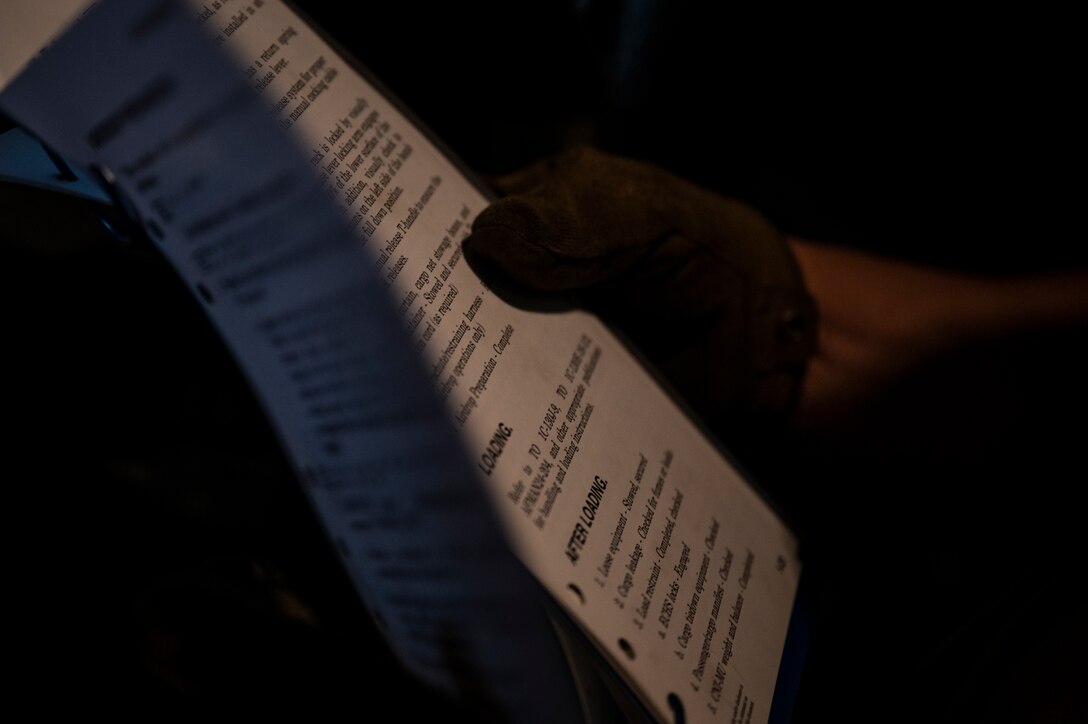 An Airman reviews a checklist