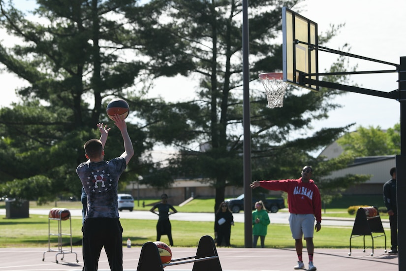 Airmen participate in a basketball game during Wingman/Shipmate Day at Joint Base Andrews, Md., May 11, 2021. Wingman/Shipmate Day consisted of various  competitions for JBA Airmen and Sailors such as basketball, golf, tennis, music and other family events. (U.S. Air Force photo by Airman 1st Class Bridgitte Taylor)