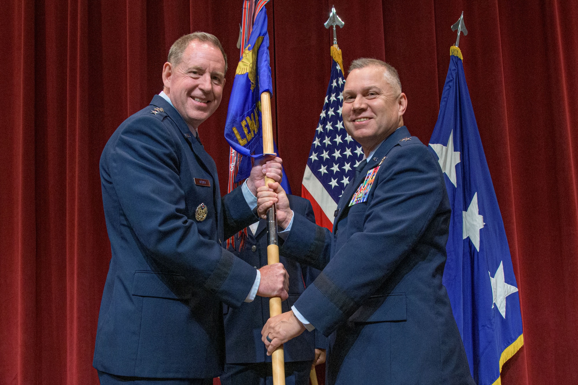 Lieutenant Gen. James B. Hecker (left), commander and president, Air University, passes the guidon to Maj. Gen. William G. Holt II at Maxwell Air Force Base, Alabama, May 24, 2021.