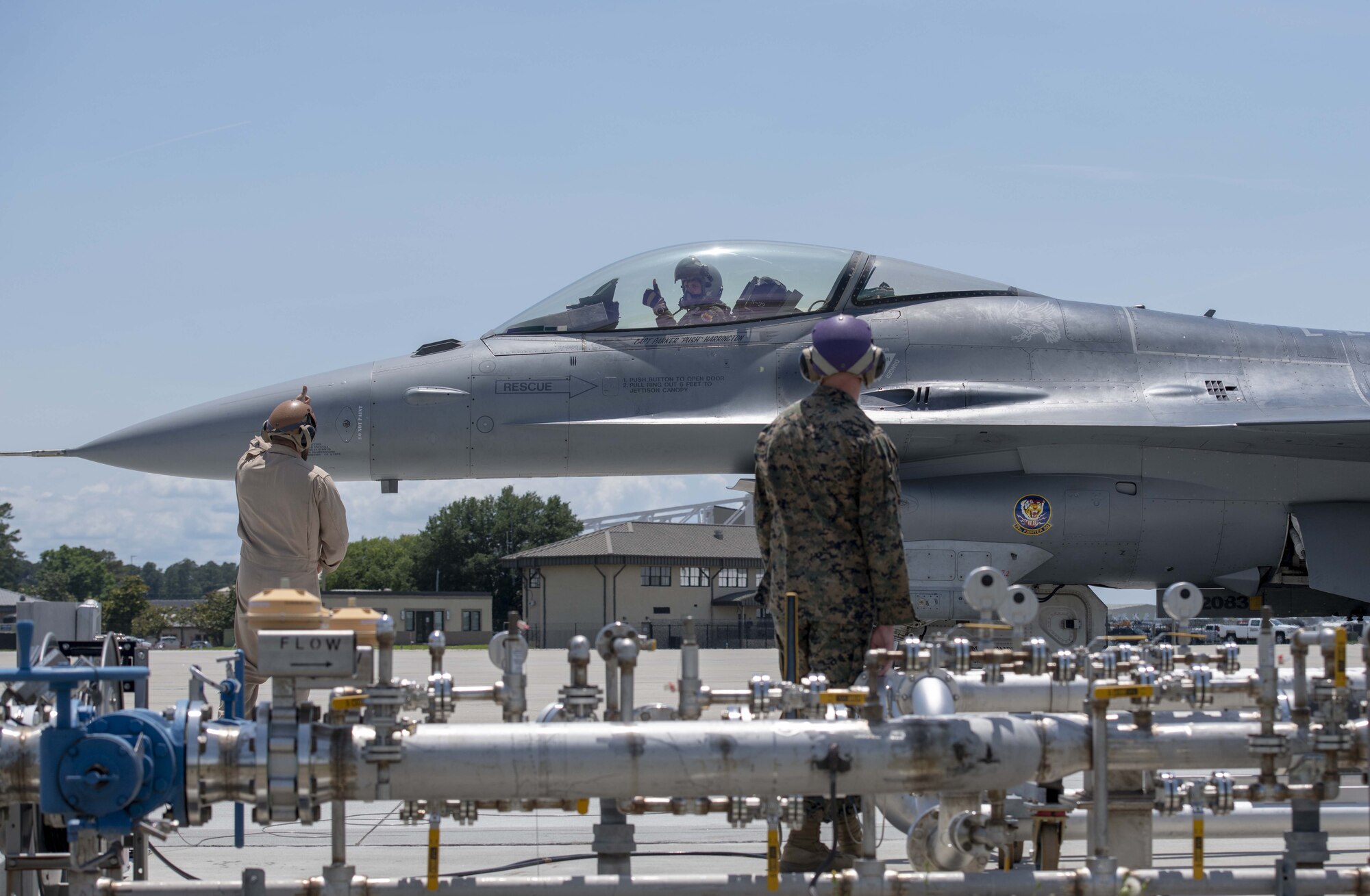 A photo of military members standing near a jet.