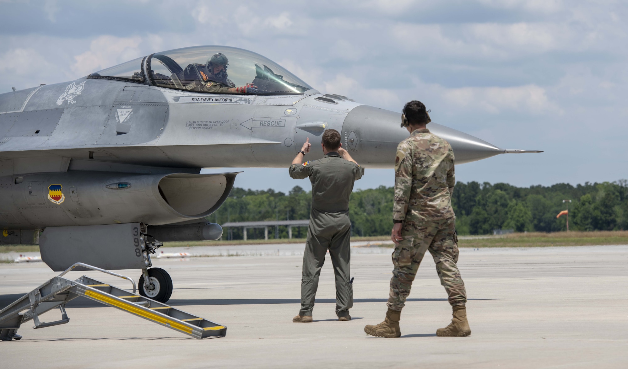A photo of Airmen marshalling a jet.