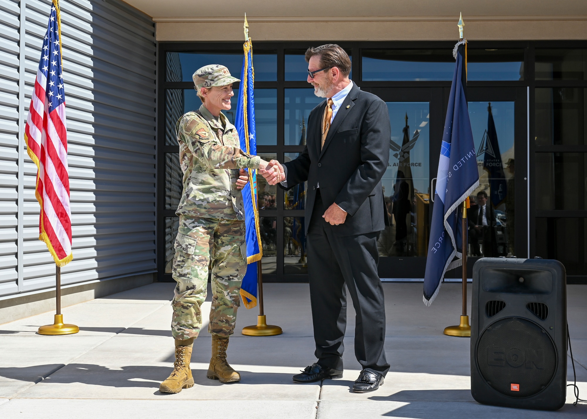 Air Force Research Laboratory Commander Maj. Gen. Heather Pringle presents the AFRL coin to Bradley Rieck, AFRL senior facility engineer, at the Space Warfighting Operations Research and Development laboratory ribbon cutting ceremony, held May 20 at Kirtland AFB, N.M. (U.S. Air Force photo/Tech. Sgt. Jenna Bigham)