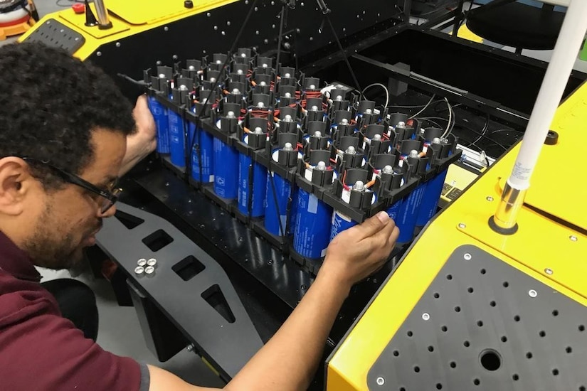A man installs a lithium battery.