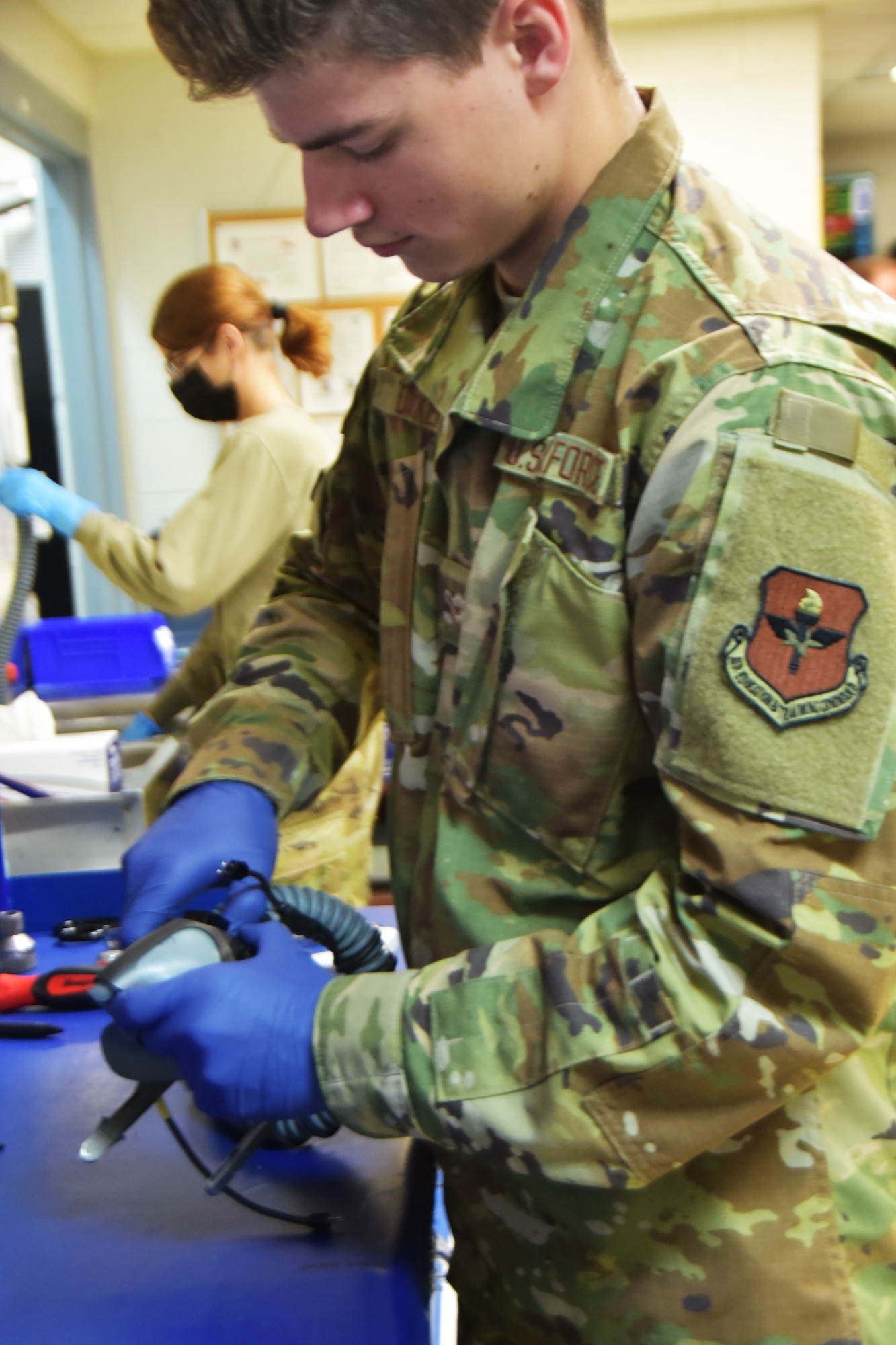 Airman Benjamin Dicker inspects an MBU-20/P oxygen mask