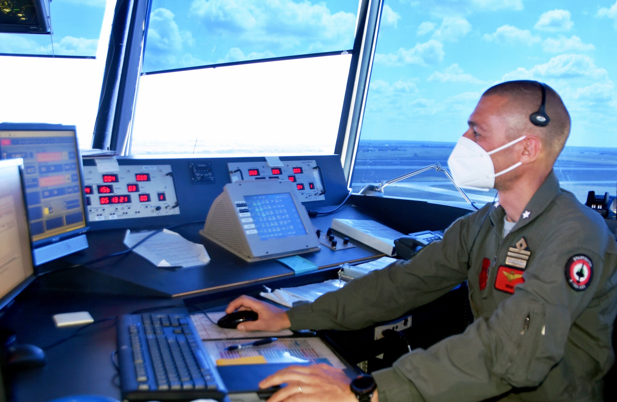Lt. Col. Enrico Luisi monitors incoming and outbound flights inside the air traffic control tower