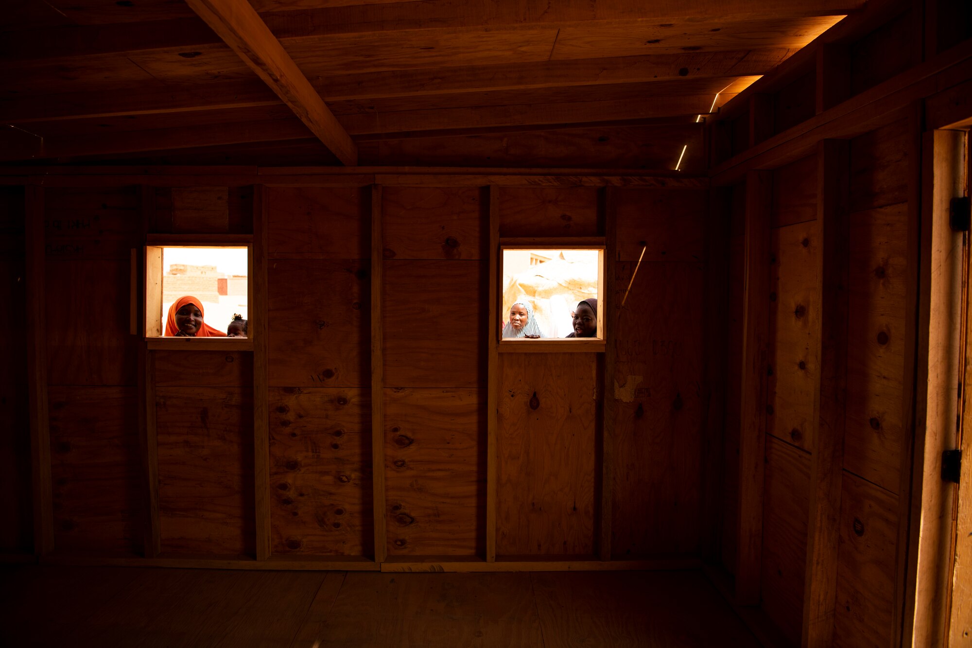 Nigerien women look into the newly constructed classroom in a village outside of Agadez, Niger. U.S. Army Civil Affairs and Airmen from Air Base 201. leave the base weekly to build partnerships with their host nation and its citizens.(U.S. Air Force photo by Tech. Sgt. Perry Aston)