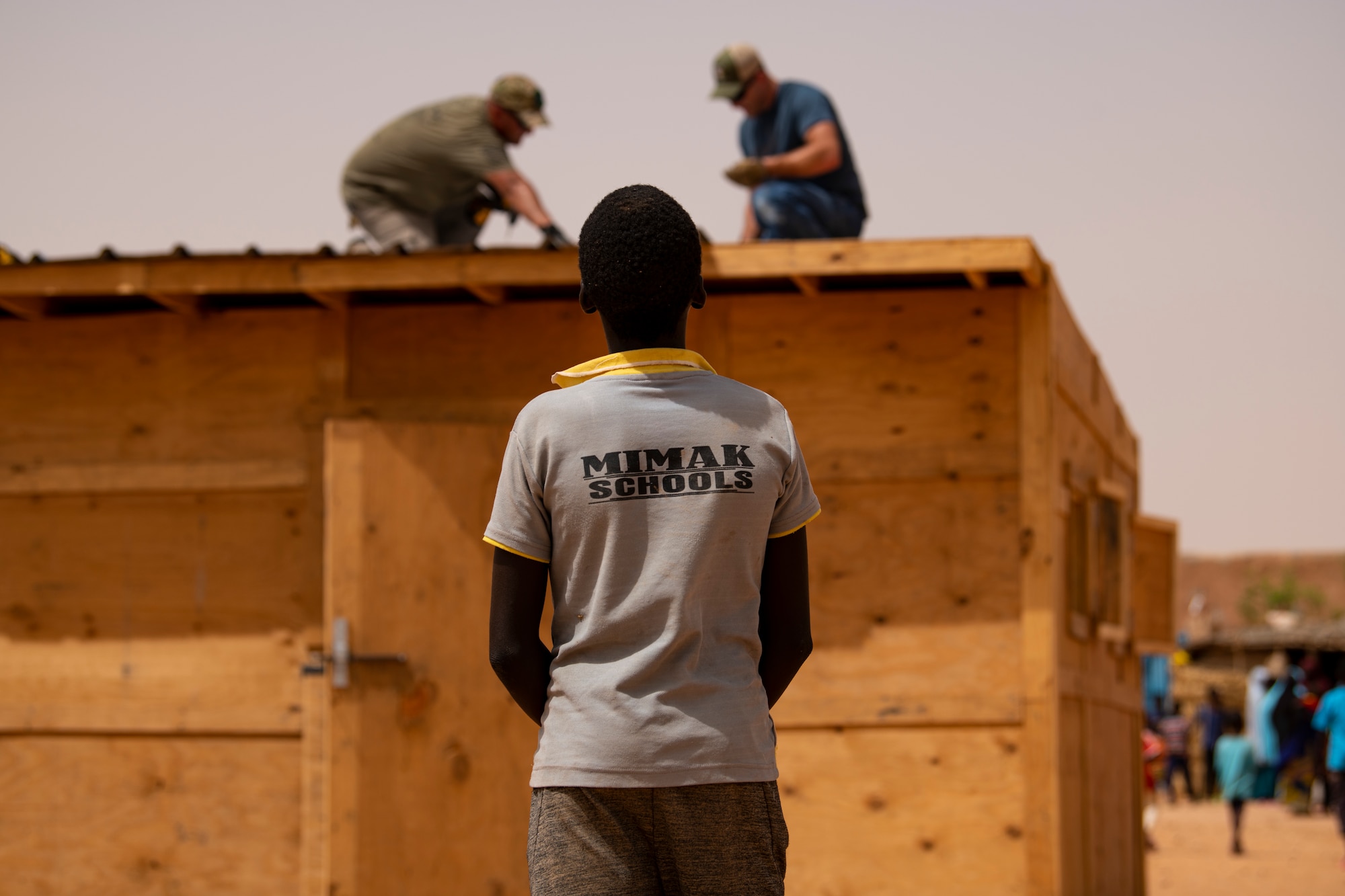 Airmen assigned to the 724th Expeditionary Air Base Squadron civil engineer flight install tin roofing on a classroom at a village in Agadez, Niger, June 27, 2019. Niger has one of the fastest growing population, resulting in not enough classrooms to teach the countries children. (U.S. Air Force photo by Tech. Sgt. Perry Aston)