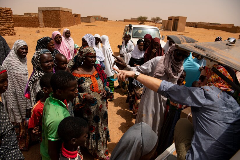 U.S. Airmen and Soldiers from Air Base 201 remove donated supplies for local Nigeriens at a village in Agadez, Niger, June 27, 2019. leave the base weekly to build partnerships with their host nation and its citizens.(U.S. Air Force photo by Tech. Sgt. Perry Aston) (U.S. Air Force photo by Tech. Sgt. Perry Aston)
