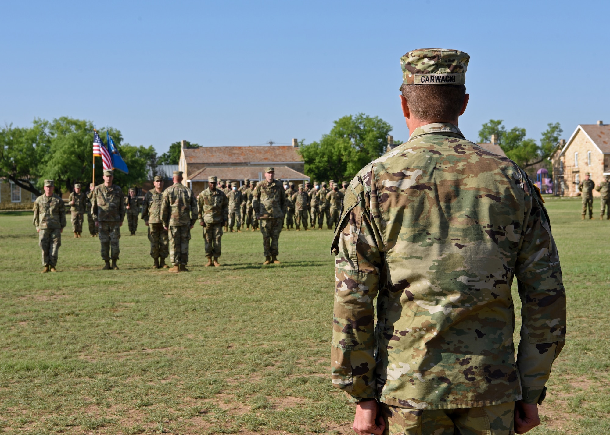 U.S. Army Lt. Col. Joe Garwacki, incoming 344th Military Intelligence Battalion commander, observes his new battalion at the 344th MI BN Change of Command ceremony at Fort Concho, in San Angelo, Texas, May 21, 2021. Garwacki graduated from Shippensburg University, Pennsylvania with a bachelor’s degree in criminal justice and also graduated from the Liberty University with master’s degree in business administration. (U.S. Air Force photo by Senior Airman Abbey Rieves)
