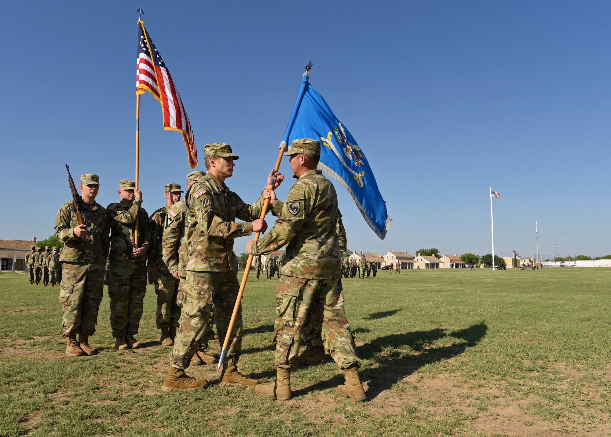 U.S. Army Lt. Col. Joe Garwacki, incoming 344th Military Intelligence Battalion commander, receives the guidon from Col. Loren Traugutt, 111th Military Intelligence Brigade commander, at the 344th MI BN Change of Command ceremony at Fort Concho, in San Angelo, Texas, May 21, 2021. Through the passing of the guidon, Traugutt accepted command from Lt. Col. Brian Ryan, outgoing 344th MI BN commander, and transferred responsibility for accomplishing the mission and the welfare of the Soldiers to Garwacki. (U.S. Air Force photo by Senior Airman Abbey Rieves)