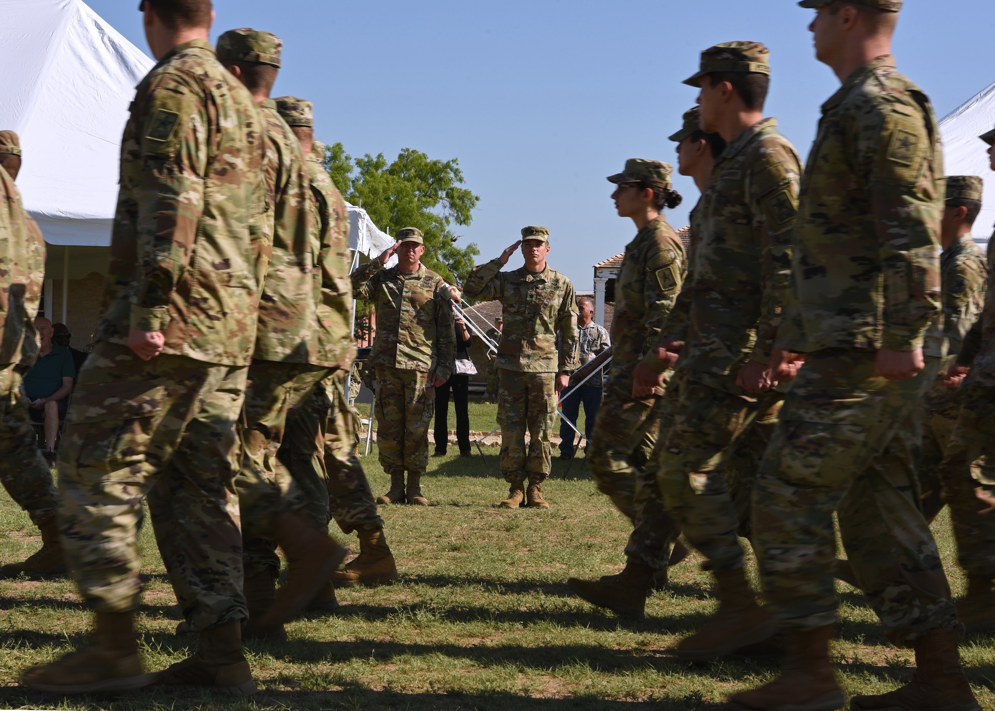 U.S. Army Soldiers from the 344th Military Intelligence Battalion march past Col. Loren Traugutt, 111th Military Intelligence Brigade commander, and Lt. Col. Joe Garwacki, incoming 344th MI BN commander, during the Pass and Review portion of the 344th MI BN Change of Command ceremony at Fort Concho, in San Angelo, Texas, May 21, 2021. The Pass and Review is a long-standing military tradition that began as a way for newly assigned commanders to inspect his or her new troops. (U.S. Air Force photo by Senior Airman Abbey Rieves)