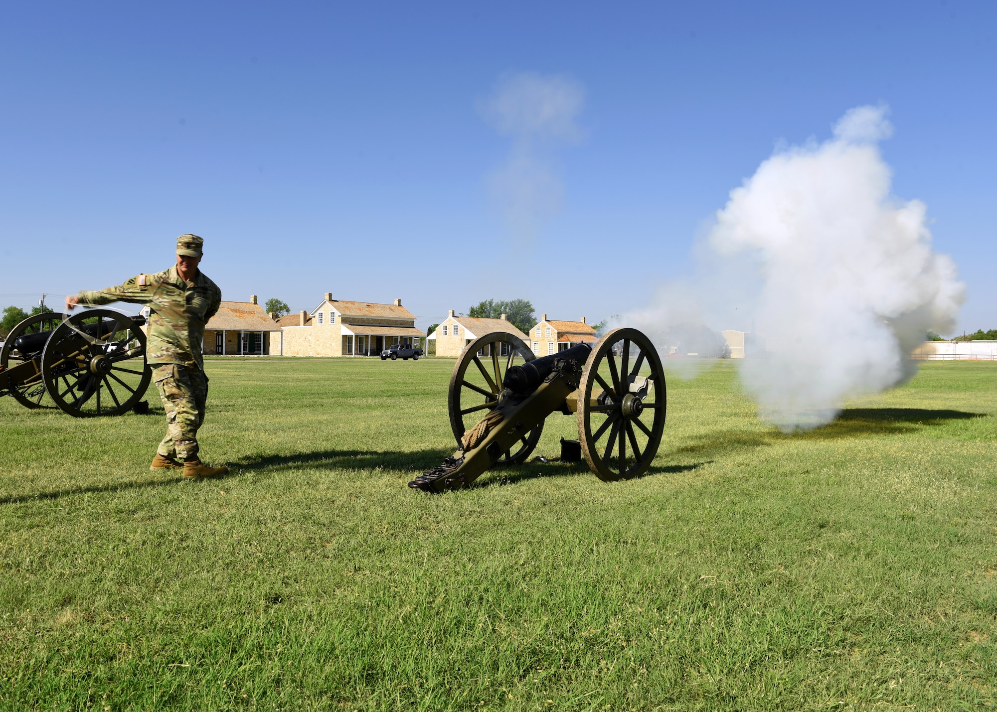 U.S. Army Lt. Col. Brian Ryan, outgoing 344th Military Intelligence Battalion commander, ignites a cannon at the 344th MI BN Change of Command ceremony at Fort Concho, in San Angelo, Texas, May 21, 2021. Ryan fired the cannon to signify leaving his command with a bang. (U.S. Air Force photo by Senior Airman Abbey Rieves)