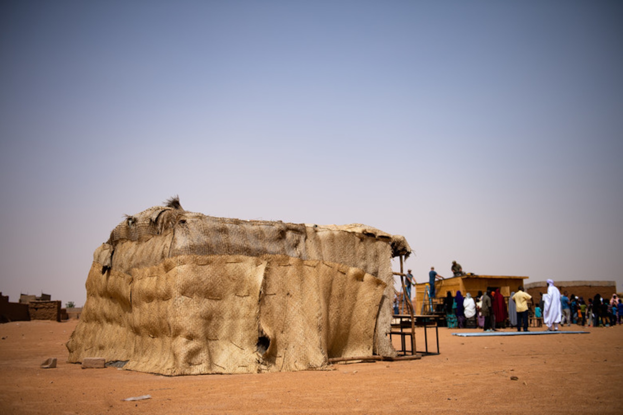 Wooden sticks and thatched roofing make up a classroom at a village in Agadez, Niger, June 27, 2019. The 724th Expeditionary Air Base Squadron civil engineer flight built the locals a new classroom made from stronger material and a tin roof to withstand the harsh conditions in Agadez. (U.S. Air Force photo by Staff Sgt. Devin Boyer)