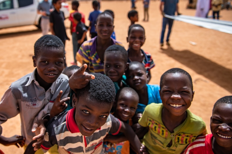 Nigerien children gather around for a photo at a village in Agadez, Niger, June 27, 2019. The 724th Expeditionary Air Base Squadron civil engineer flight built a new classroom for the village so they can learn in a more stable structure. (U.S. Air Force photo by Staff Sgt. Devin Boyer)