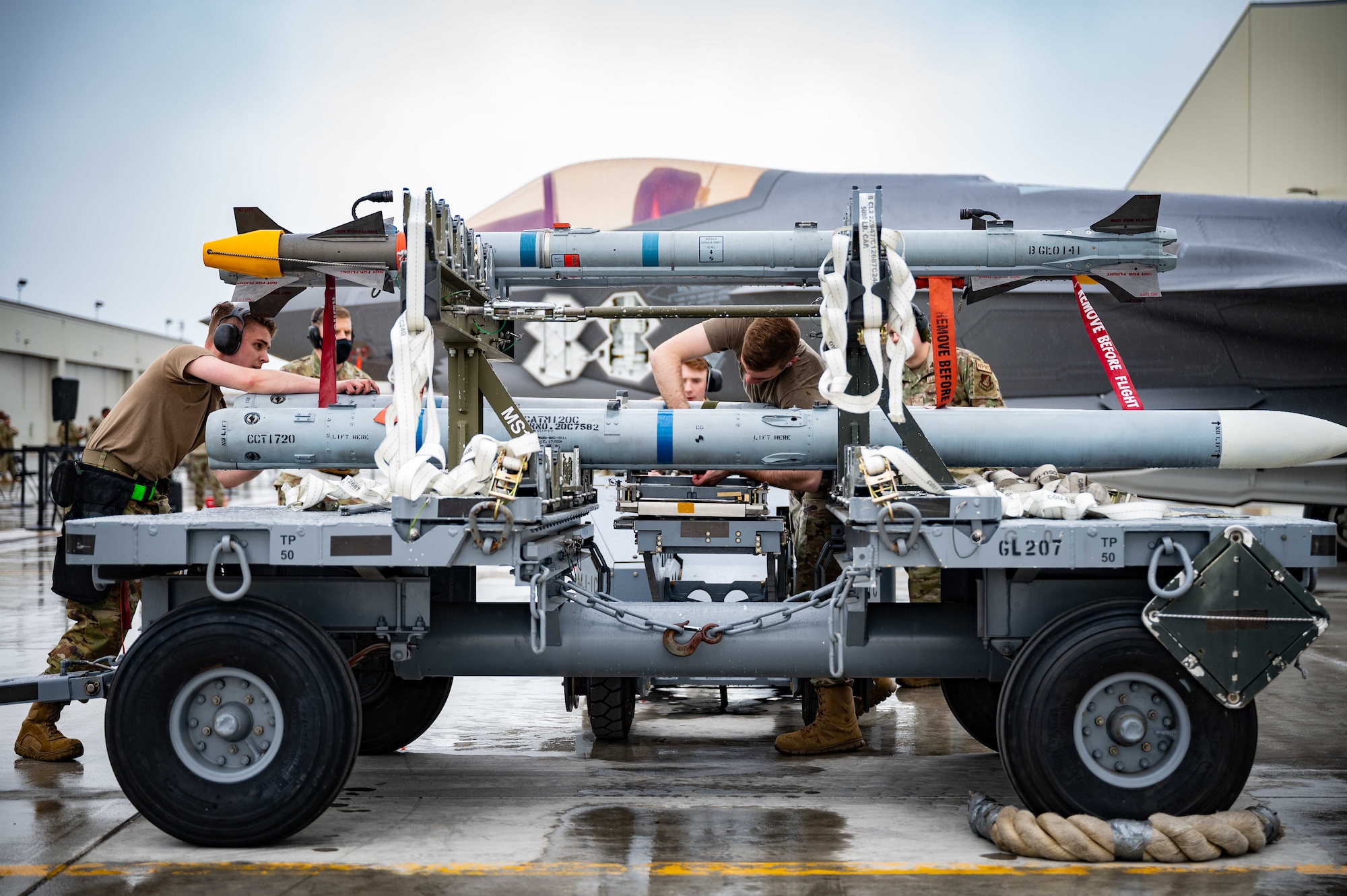 U.S. Airmen from the 356th Aircraft Maintenance Unit prepare an AIM-120 for pick-up during a load crew competition on Eielson Air Force Base, Alaska, May 21, 2021.