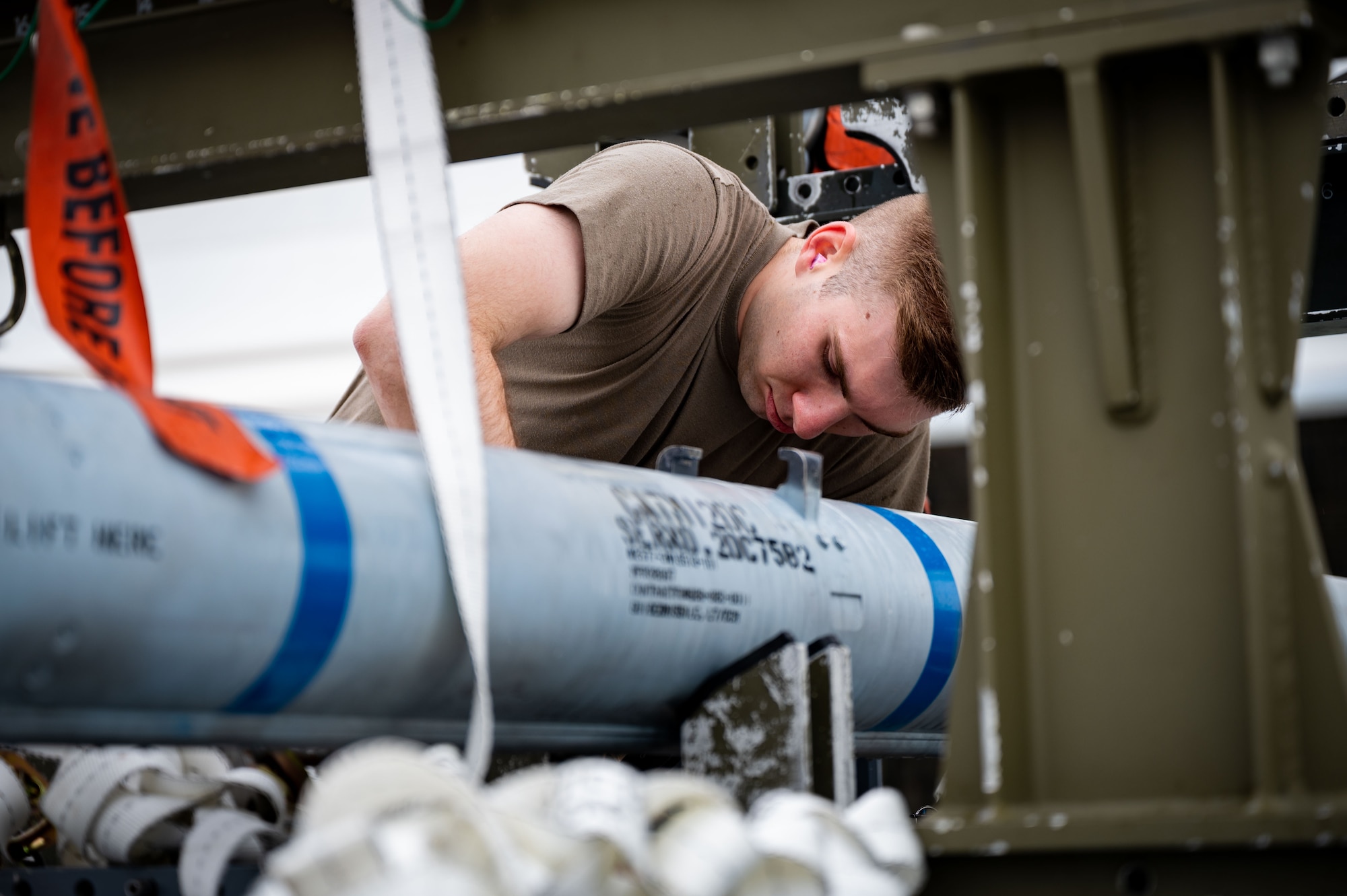 U.S. Air Force Staff Sgt. Carson Marlowe, a 356th Aircraft Maintenance Unit weapons load crew chief, prepares an AIM-120 for pick-up during a load competition on Eielson Air Force Base, Alaska, May 21, 2021.