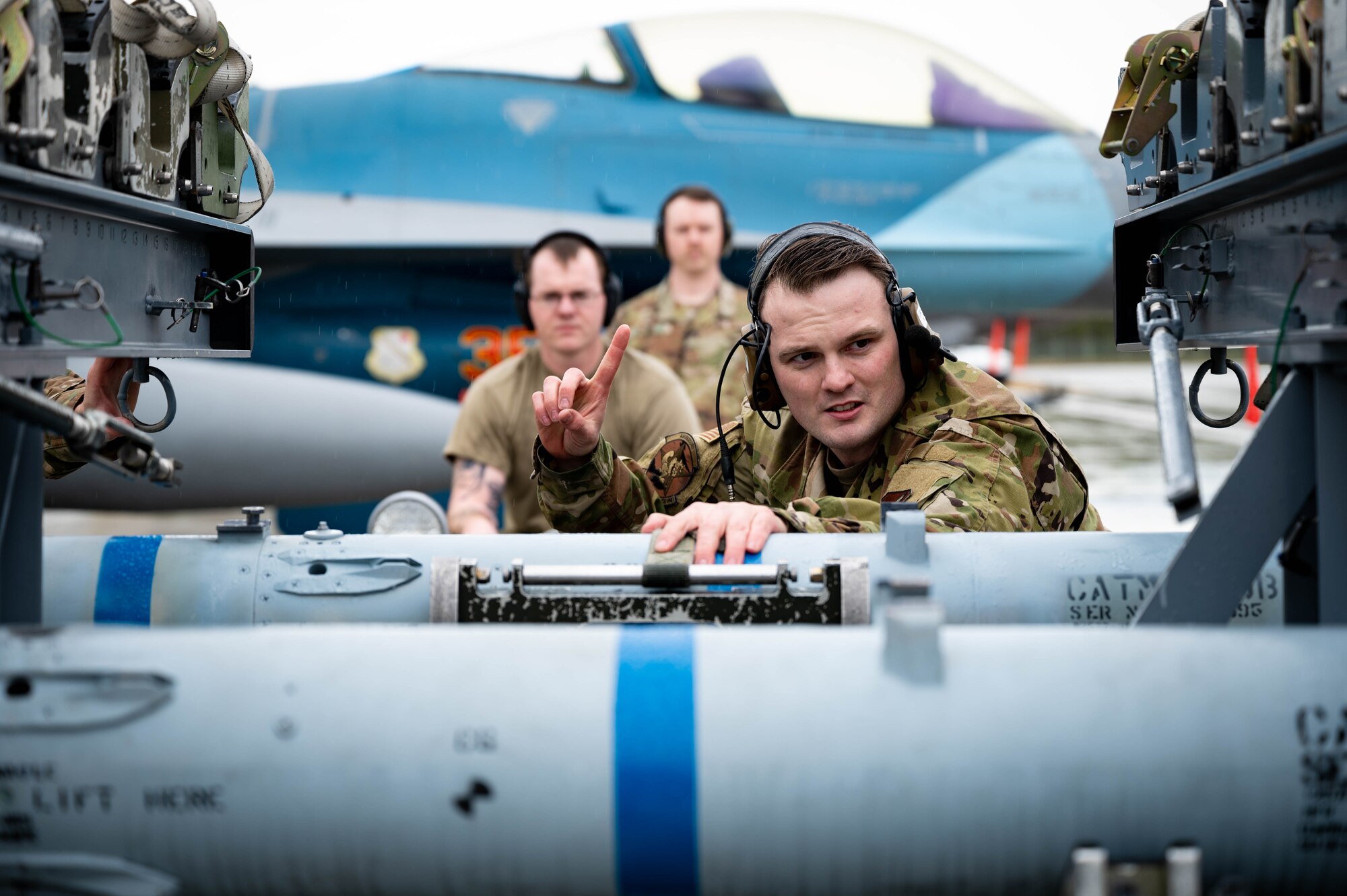 U.S. Airmen from the 18th Aircraft Maintenance Unit prepare an AIM-120 for pick-up during a load competition on Eielson Air Force Base, Alaska, May 21, 2021.