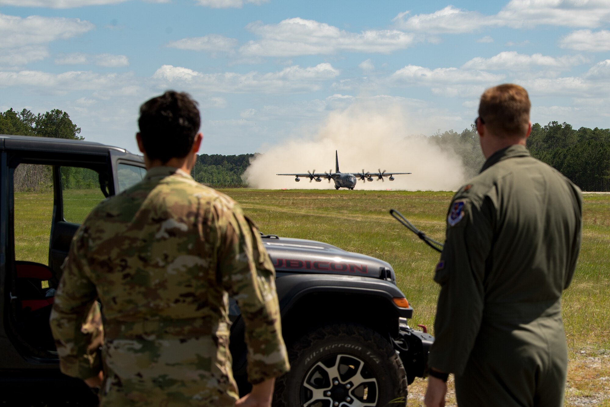 Photo of people watching an aircraft land