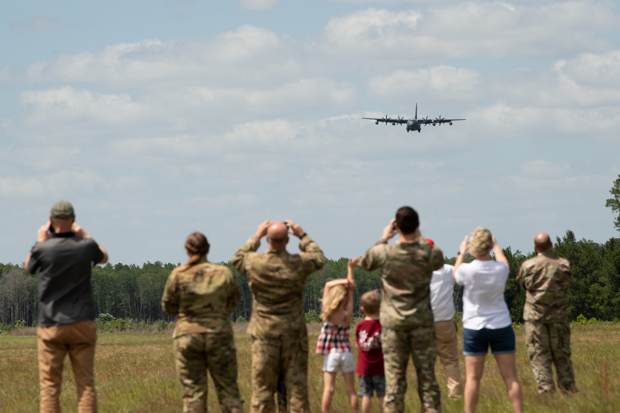 Photo of people watching an aircraft land